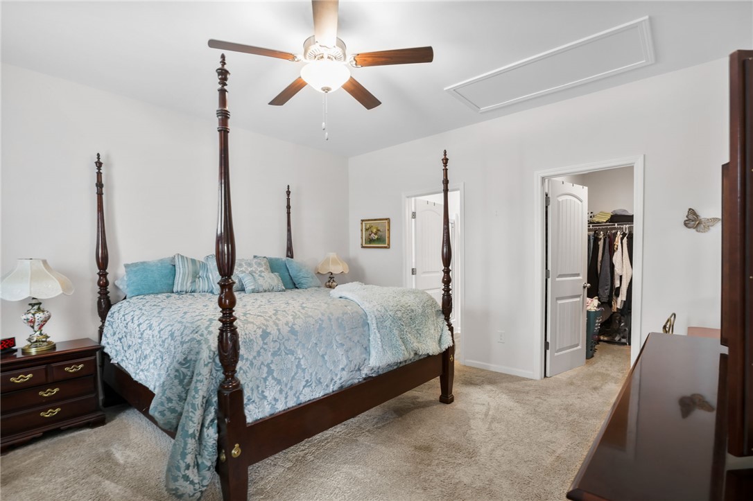 251 Samuel Street Pendleton, SC 29670 - Photo 13 of 37 This cozy bedroom features a ceiling fan, a comfortable bed, and convenient closet access.