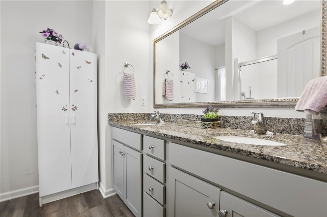 251 Samuel Street Pendleton, SC 29670 - Photo 15 of 37 This bright bathroom features a spacious vanity and a large mirror, creating an inviting and functional space.