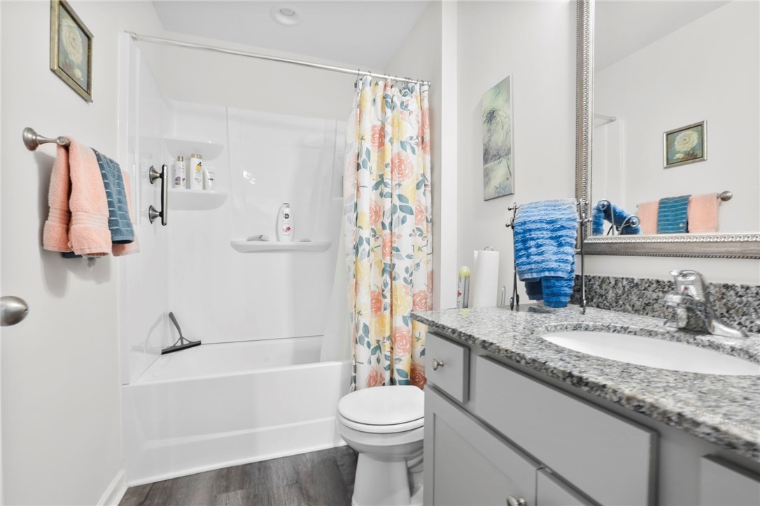 251 Samuel Street Pendleton, SC 29670 - Photo 20 of 37 This bathroom features a sleek vanity, inviting tub, and stylish tile flooring, creating a relaxing ambiance.