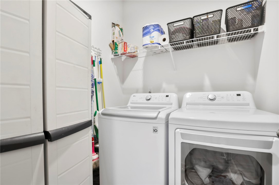 251 Samuel Street Pendleton, SC 29670 - Photo 25 of 37 This dedicated laundry room offers convenient appliances and practical shelving.