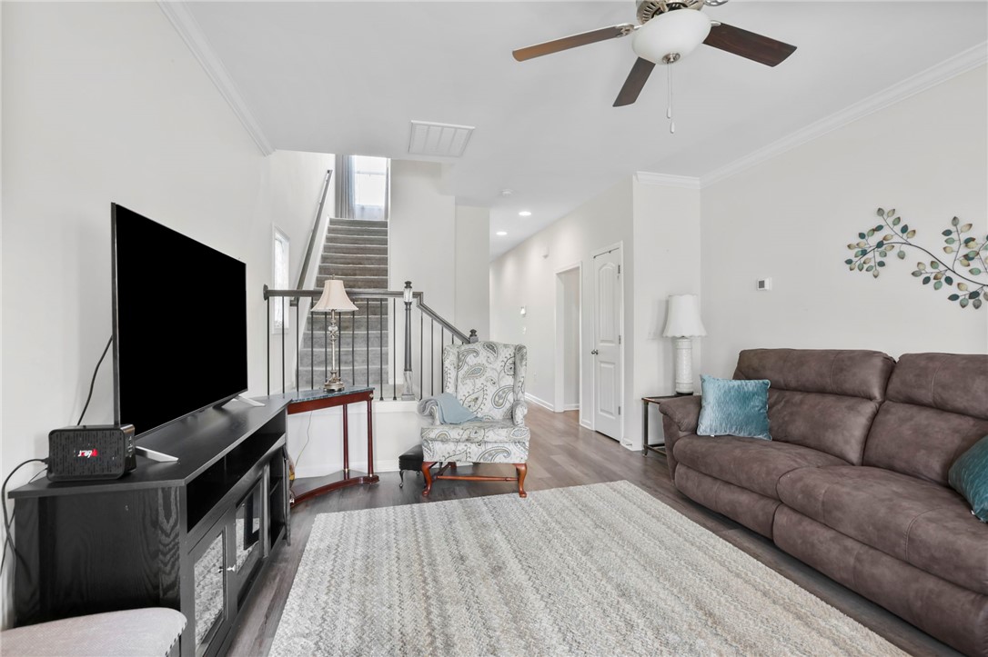 251 Samuel Street Pendleton, SC 29670 - Photo 3 of 37 This living room features ample natural light and direct access to the upper level.