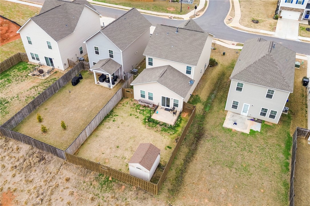 251 Samuel Street Pendleton, SC 29670 - Photo 36 of 37 This aerial view showcases a residential property featuring a fenced yard and a charming patio.