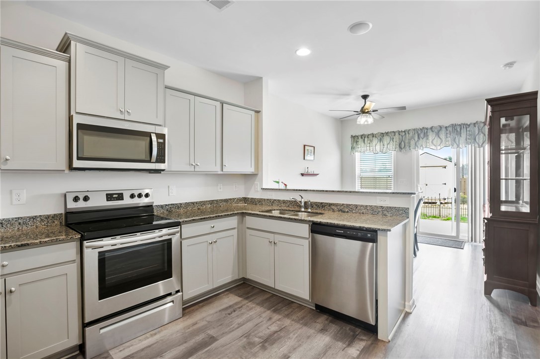 251 Samuel Street Pendleton, SC 29670 - Photo 7 of 37 This functional kitchen features ample counter space and offers easy access to the patio.