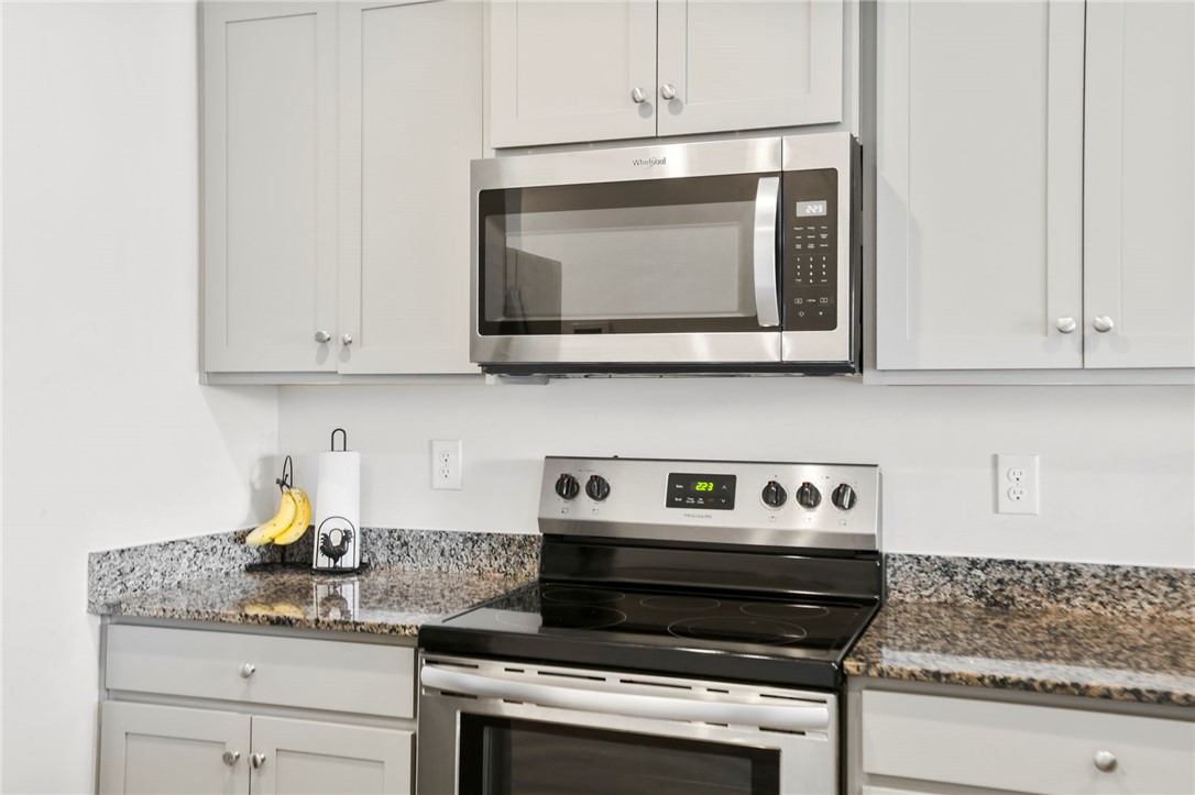 251 Samuel Street Pendleton, SC 29670 - Photo 9 of 37 This modern kitchen features sleek countertops and contemporary stainless steel appliances, creating a stylish culinary space.