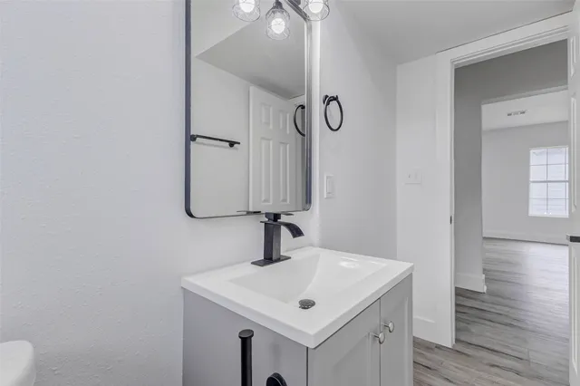 a bathroom with a sink a mirror and vanity