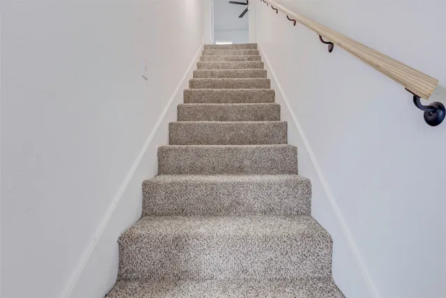 a view of staircase with white walls