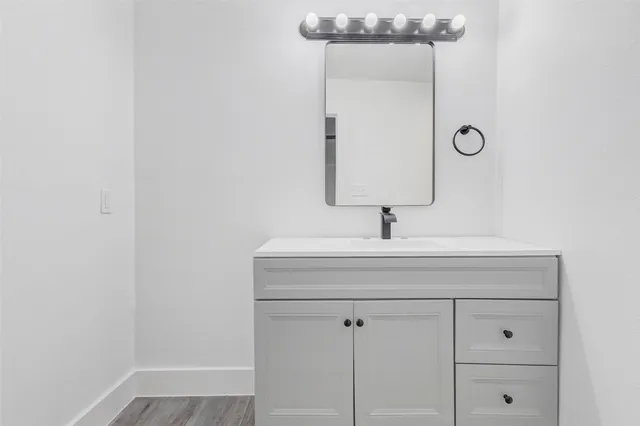 a bathroom with a sink and a mirror