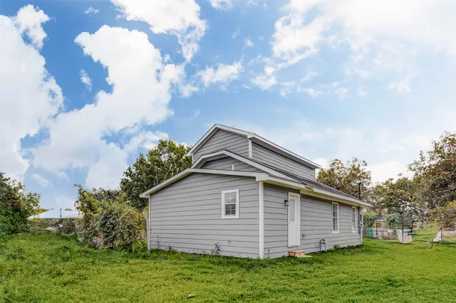 a view of house with backyard