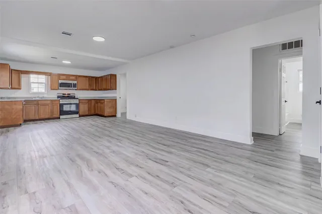 a view of a room with wooden floor and window