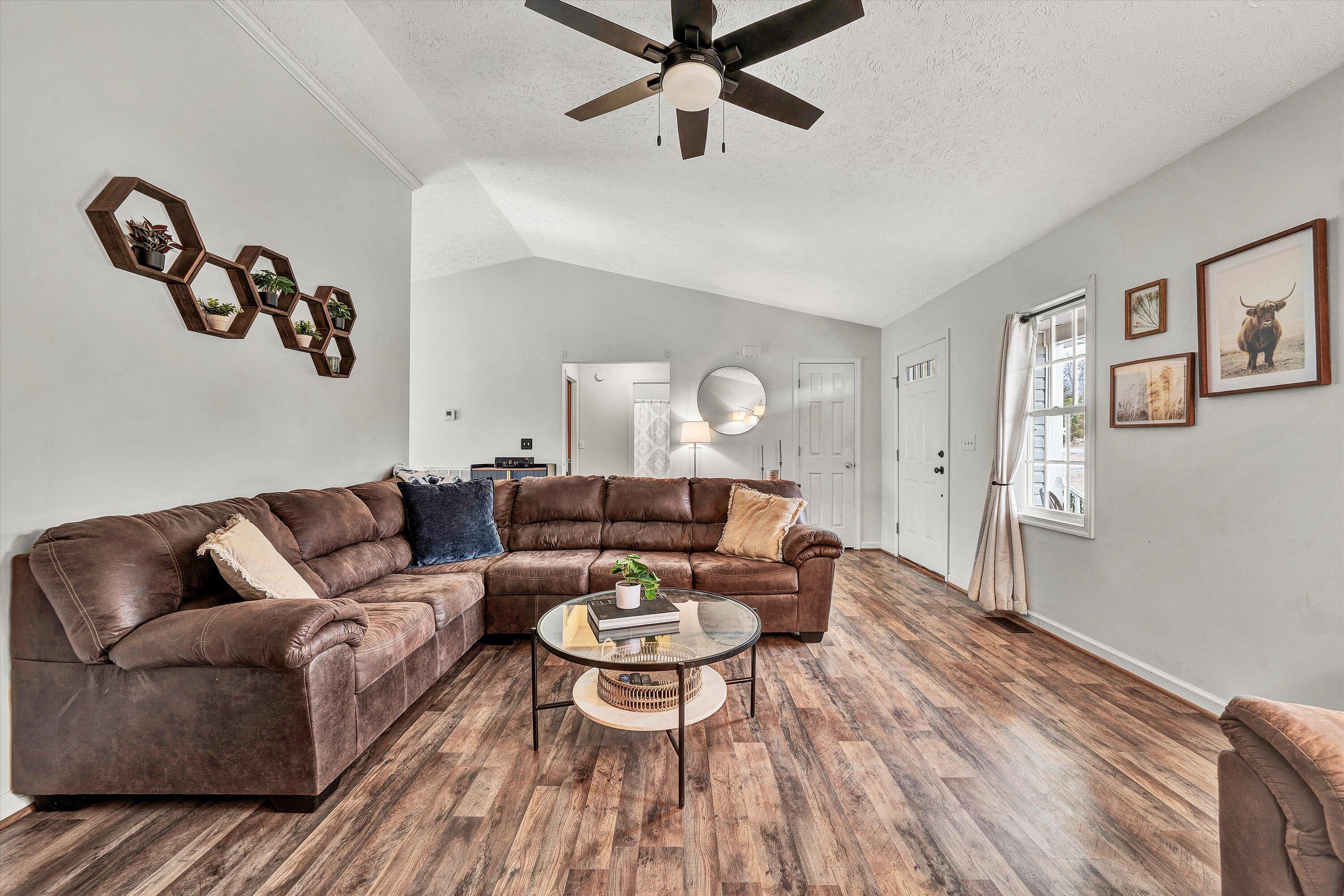 1188 Airport Road Moneta, VA 24121 - Photo 11 of 34 a living room with furniture and a wooden floor
