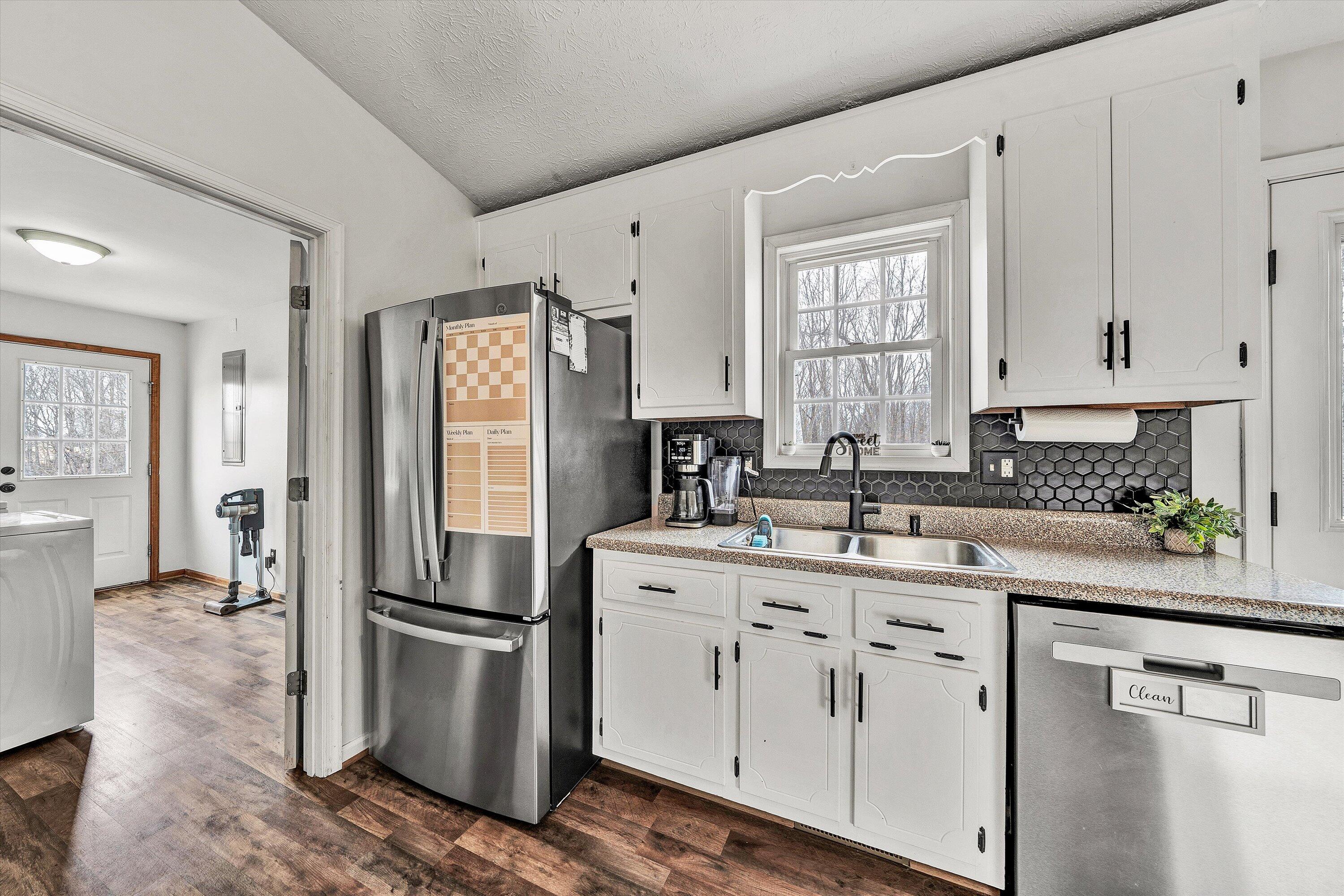 1188 Airport Road Moneta, VA 24121 - Photo 15 of 34 a kitchen with a refrigerator sink and cabinets