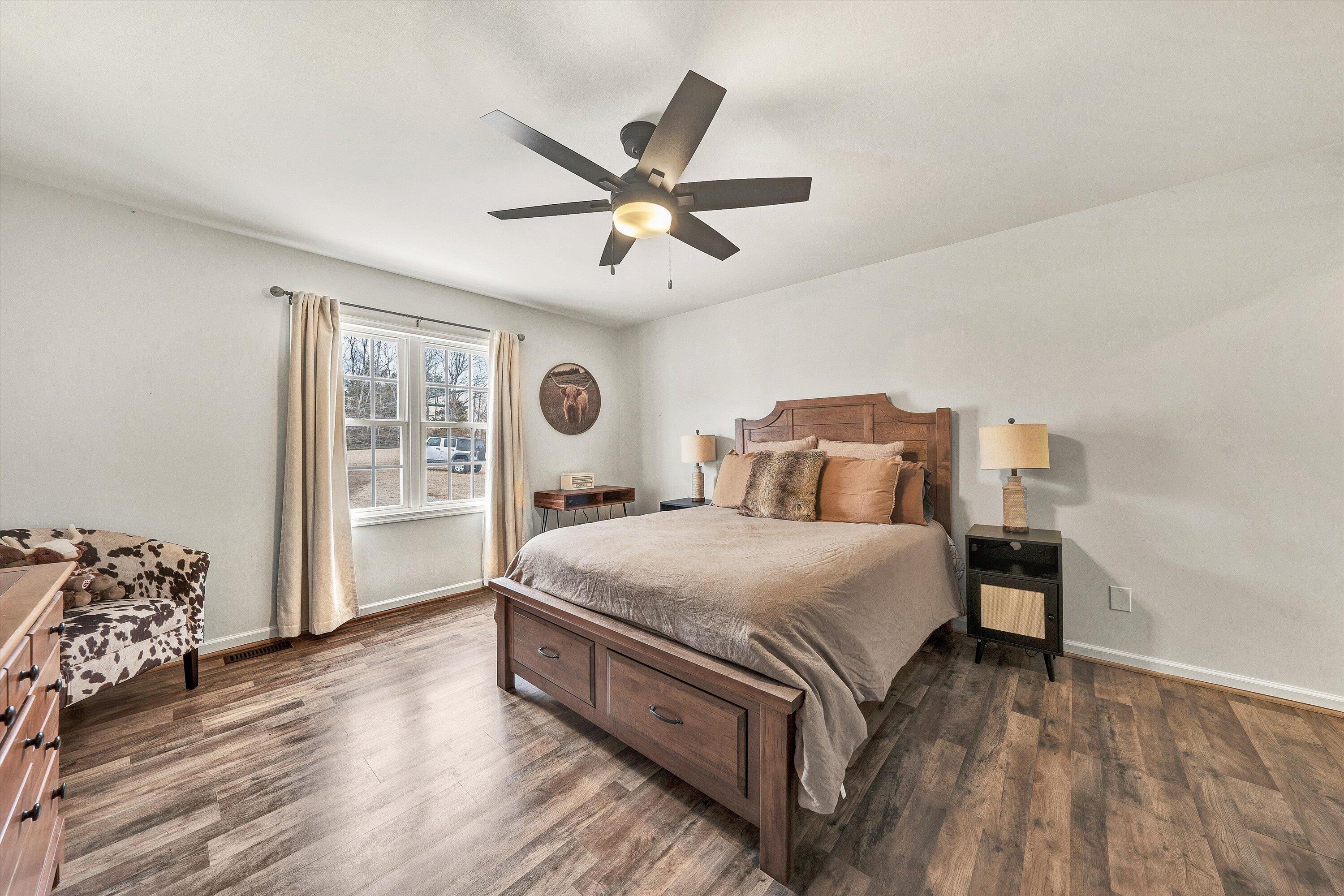 1188 Airport Road Moneta, VA 24121 - Photo 21 of 34 a bedroom with a bed and wooden floor