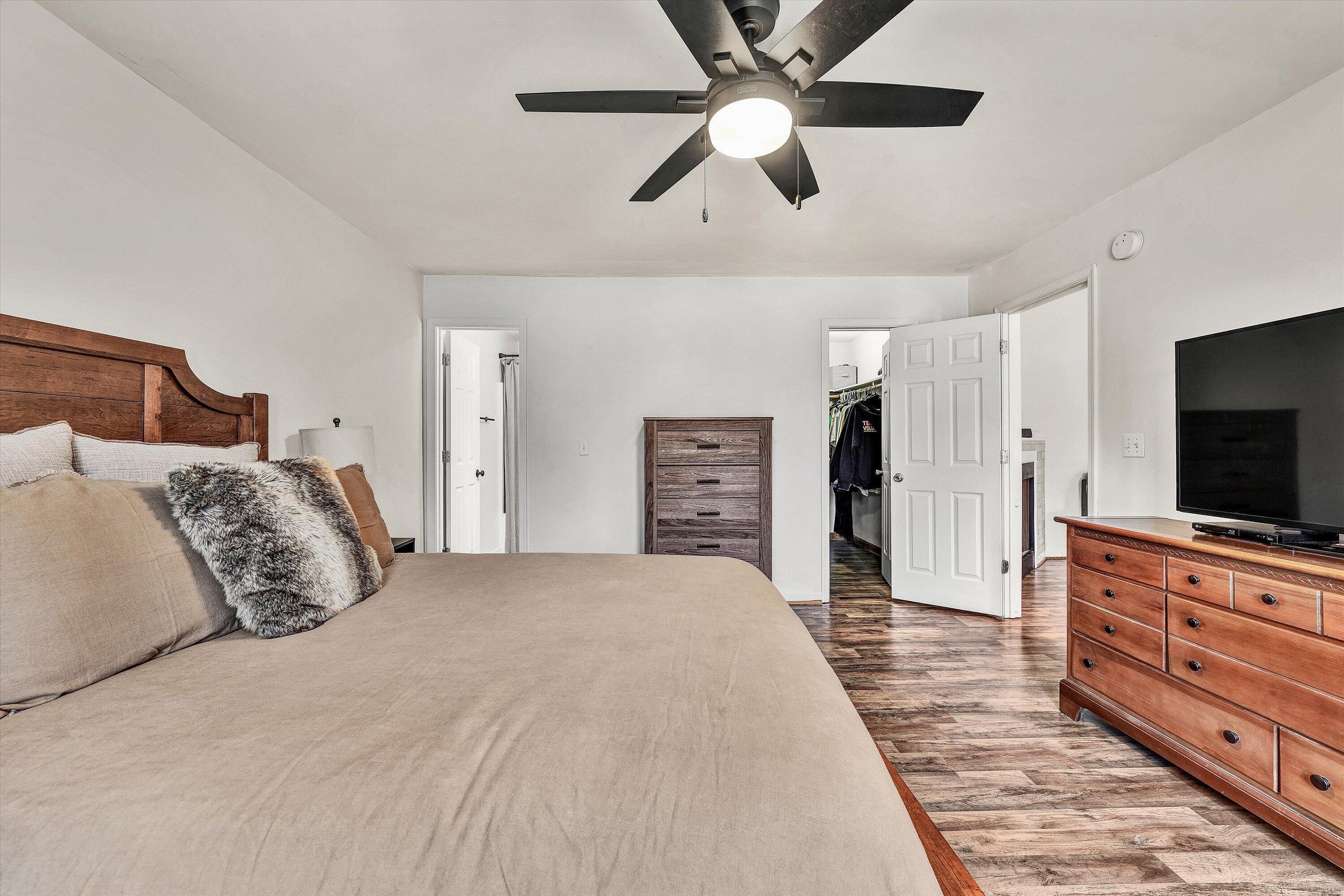 1188 Airport Road Moneta, VA 24121 - Photo 22 of 34 a bedroom with a large bed and a flat tv screen on dresser