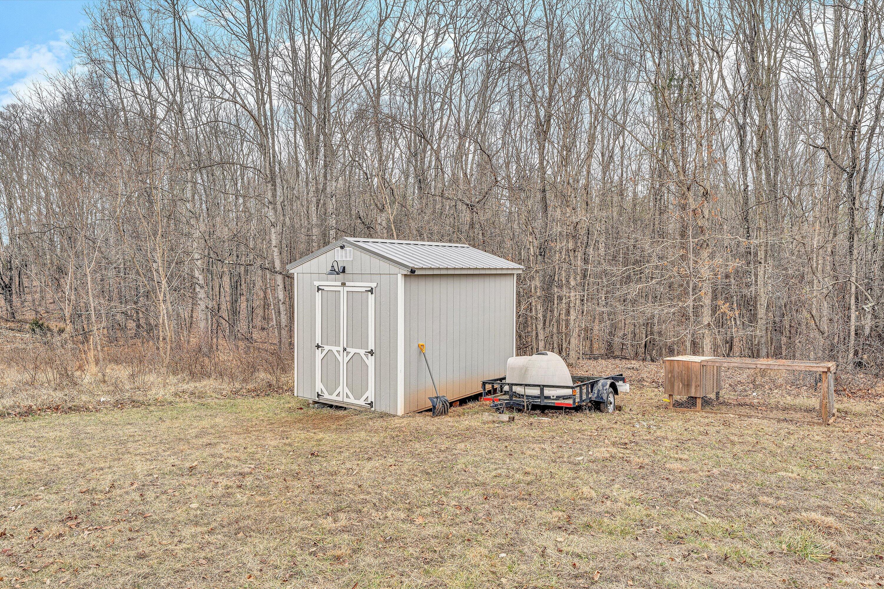 1188 Airport Road Moneta, VA 24121 - Photo 32 of 34 a backyard of a house with a small yard and wooden floor