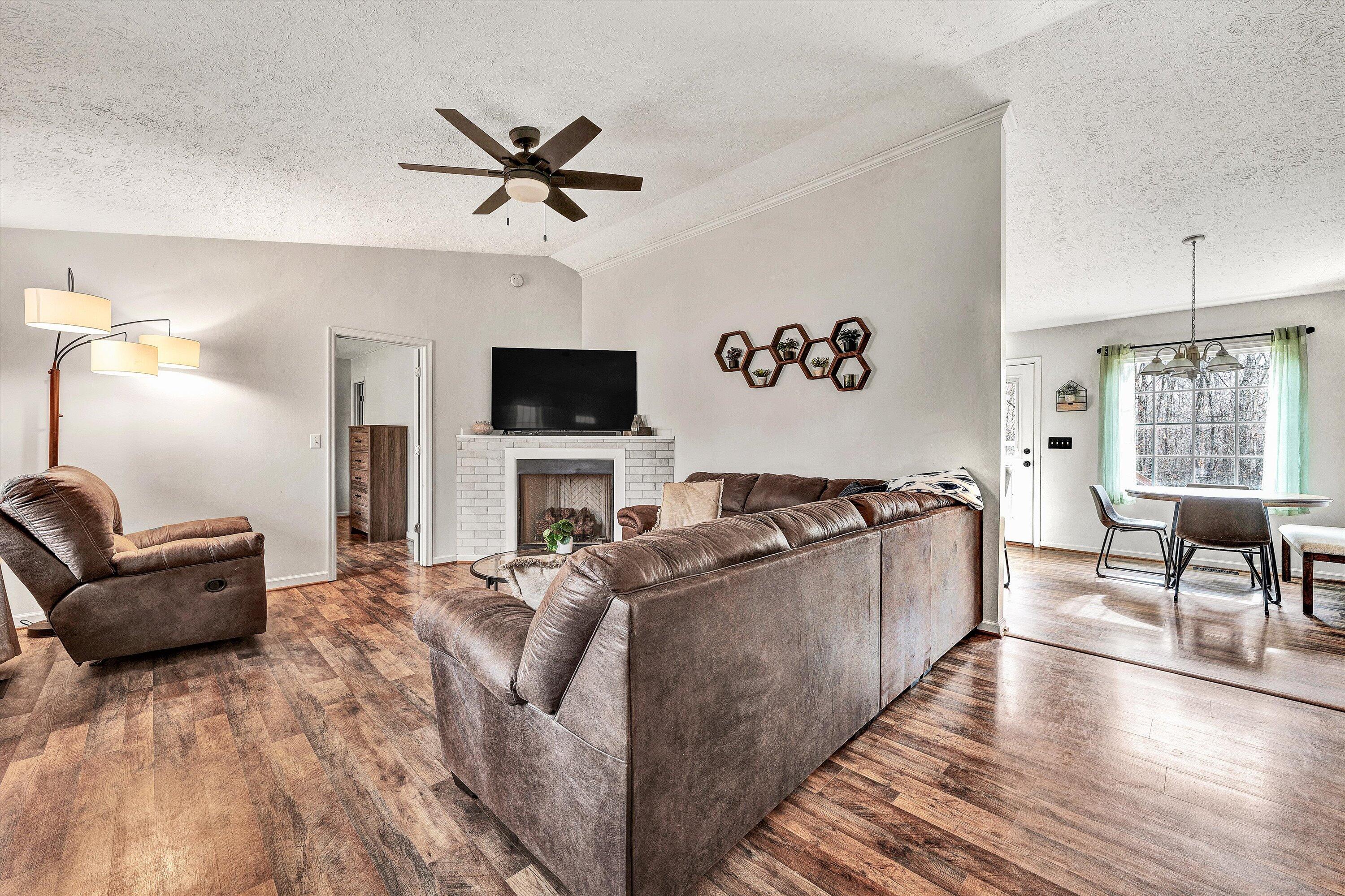 1188 Airport Road Moneta, VA 24121 - Photo 8 of 34 a living room with furniture and a flat screen tv