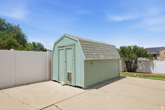 7910 Woolley Way Magna, UT 84044 - Photo 21 of 26 Outdoor storage shed with gambrel roof, double front doors, and an integrated pet door