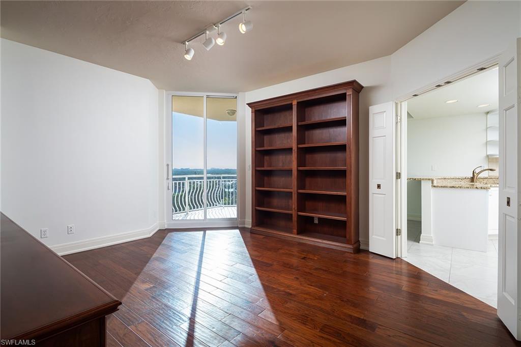 435 Dockside Drive, Unit B703 Naples, FL 34110 - Photo 22 of 38 wooden floor in an empty room with a window