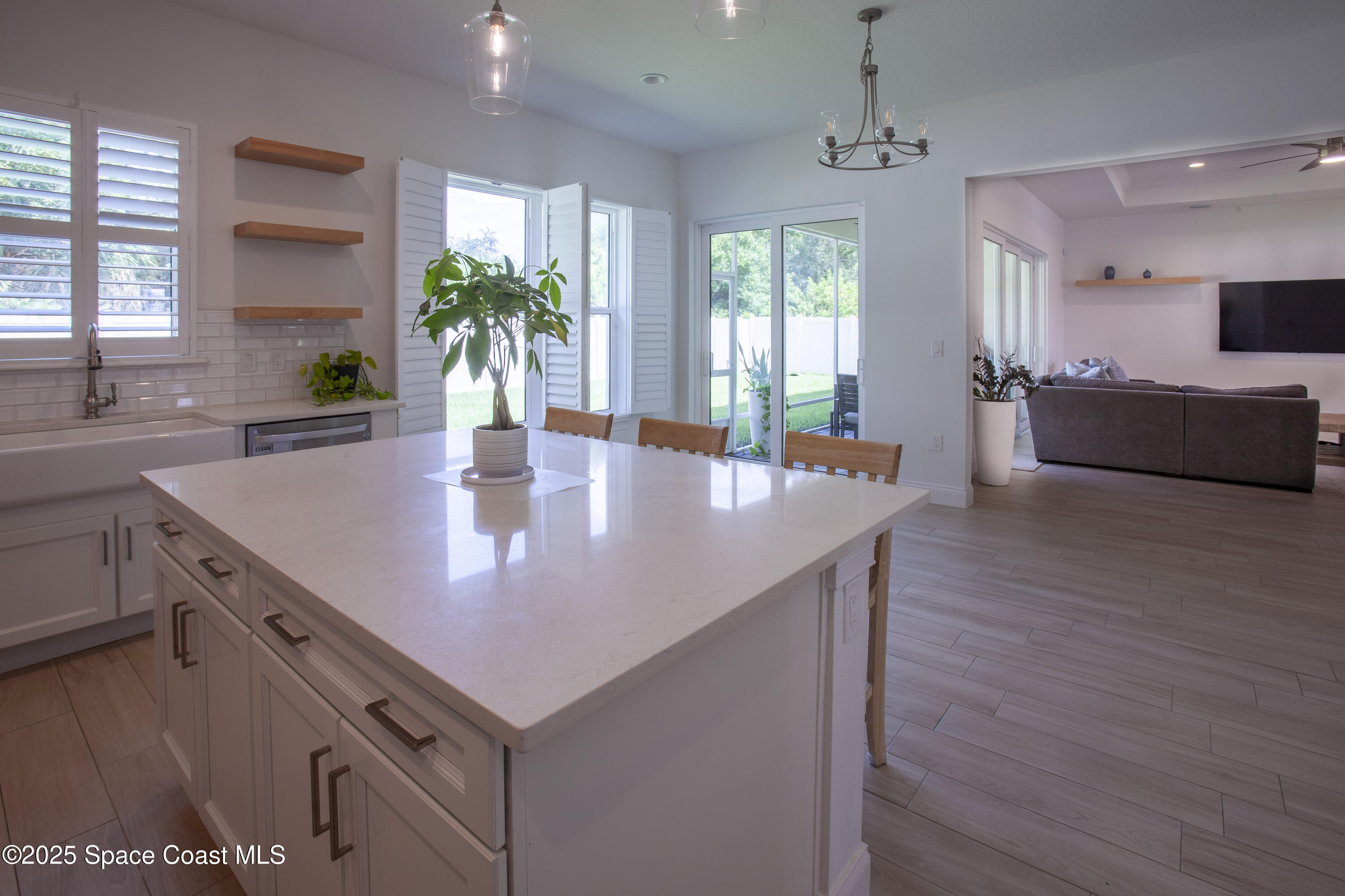 4305 Negal Circle Melbourne, FL 32901 - Photo 11 of 40 a kitchen with a stove a sink and a refrigerator