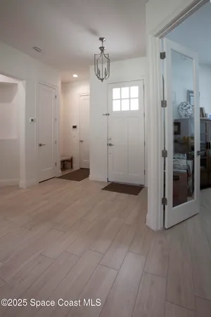 a view of a hallway with wooden floor