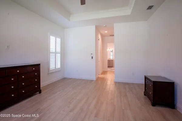 a large bed sitting in a bedroom next to a window