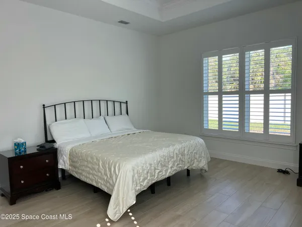 a spacious bathroom with a double vanity sink a mirror and a bathtub