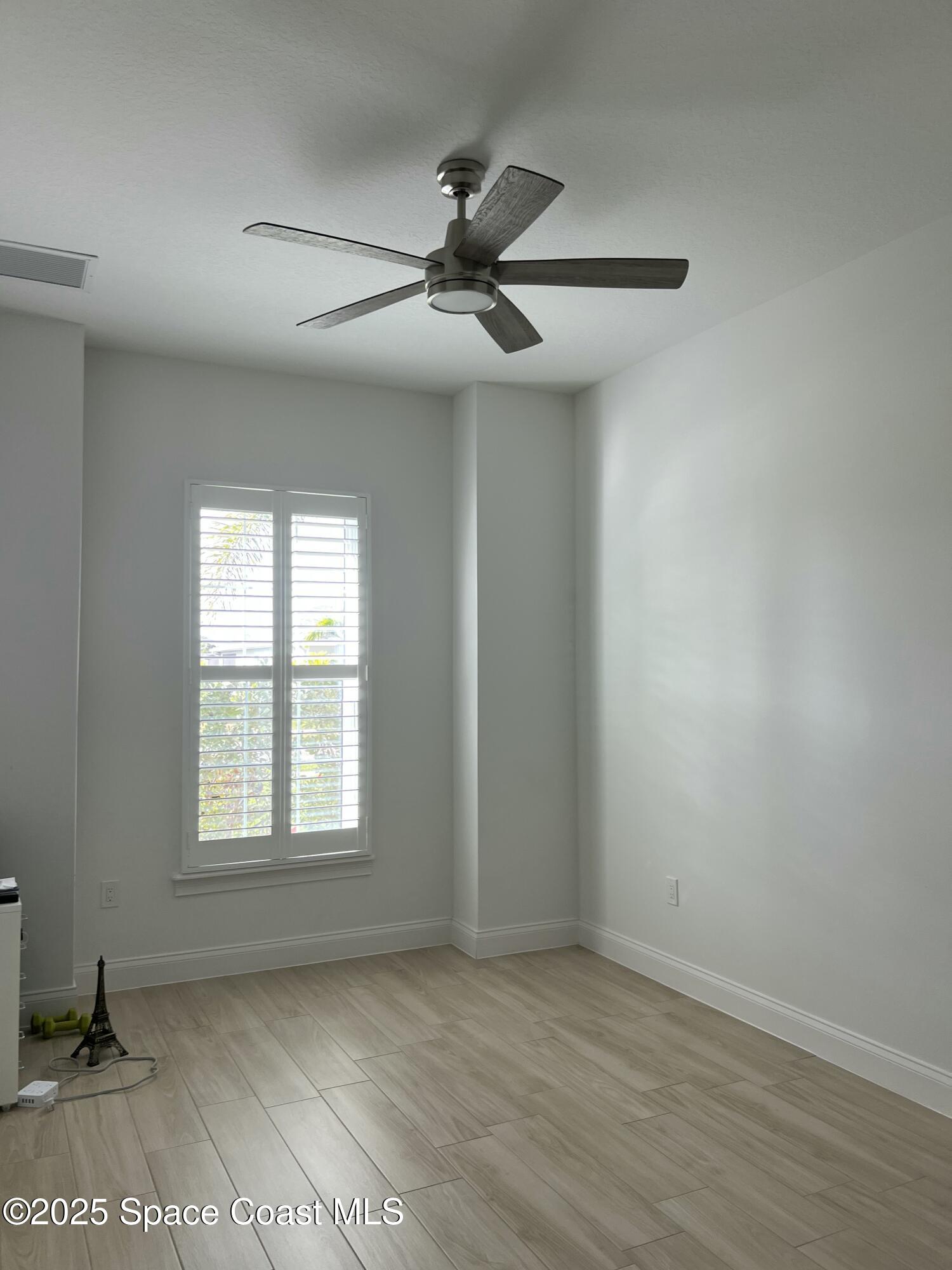 4305 Negal Circle Melbourne, FL 32901 - Photo 26 of 40 an empty room with windows and fan