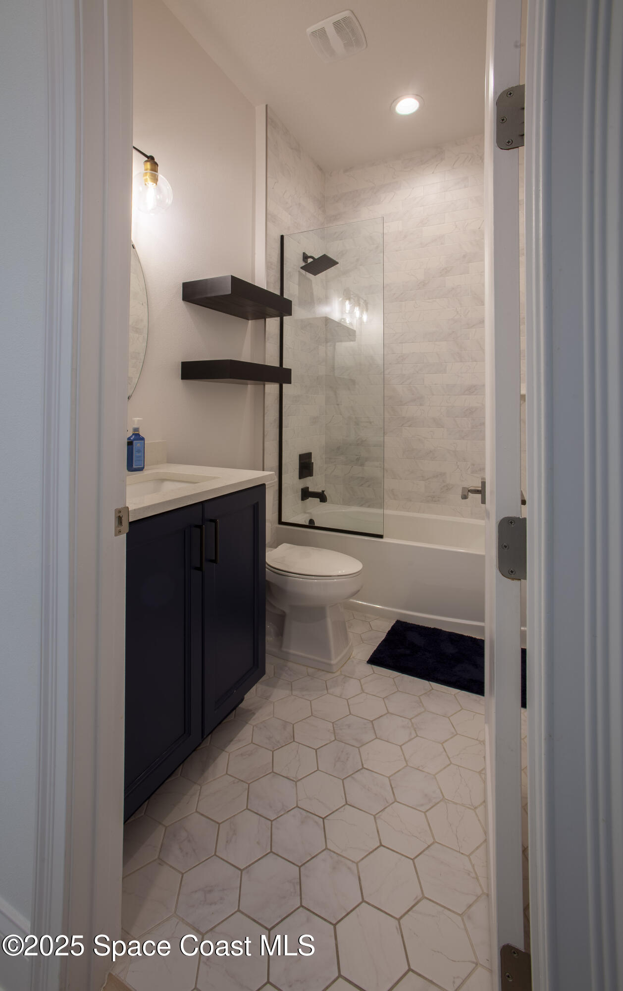 4305 Negal Circle Melbourne, FL 32901 - Photo 29 of 40 a bathroom with a bathtub and a shower