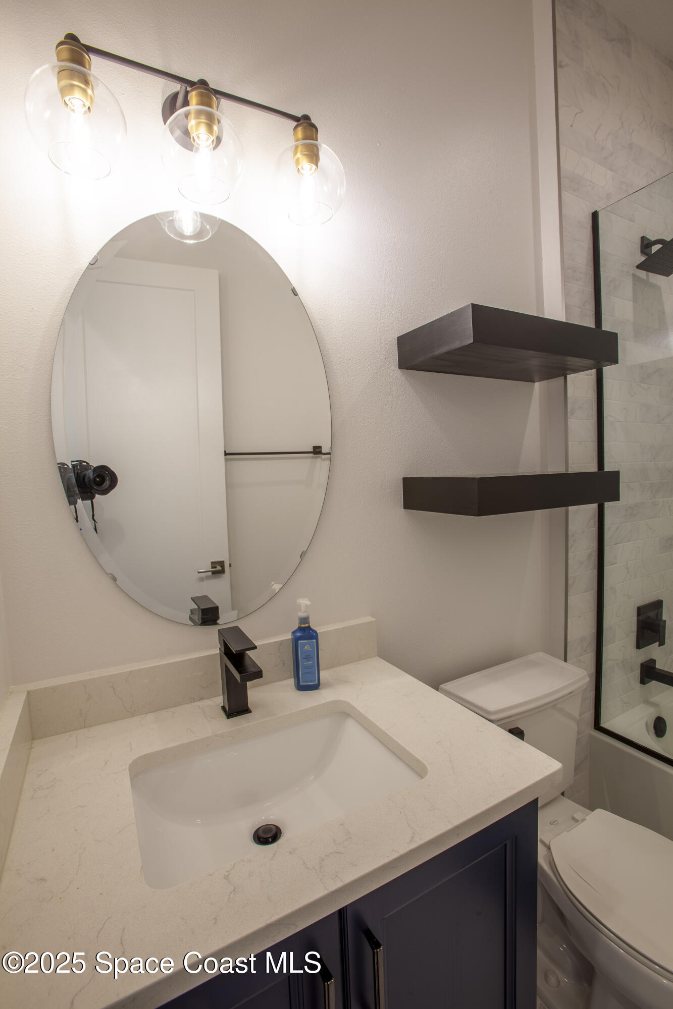 4305 Negal Circle Melbourne, FL 32901 - Photo 30 of 40 a bathroom with a sink and a mirror