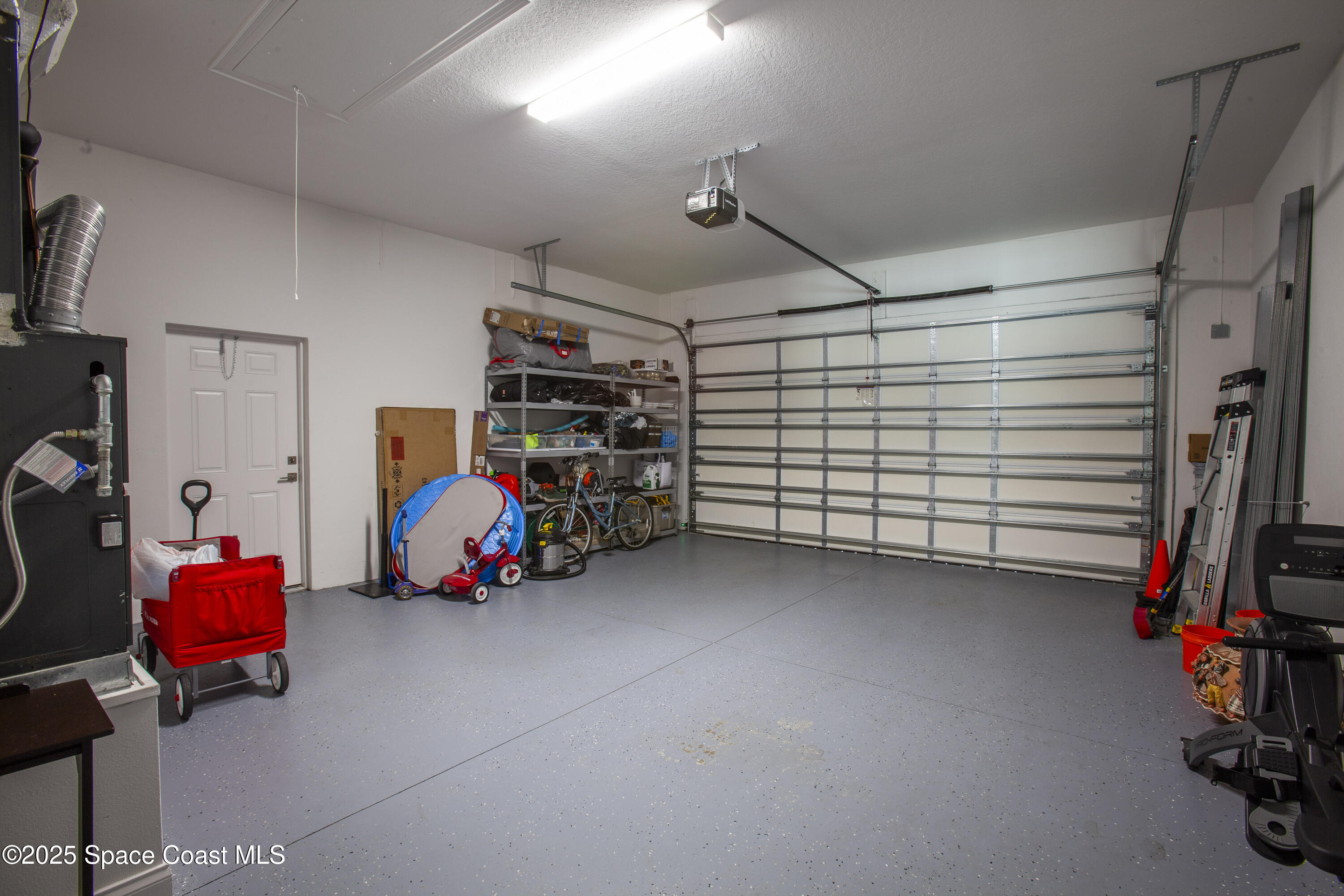 4305 Negal Circle Melbourne, FL 32901 - Photo 33 of 40 a view of a garage with rack and bicycle