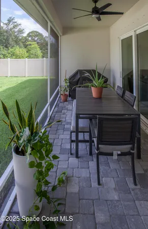 a view of a workspace with a table and chairs in patio