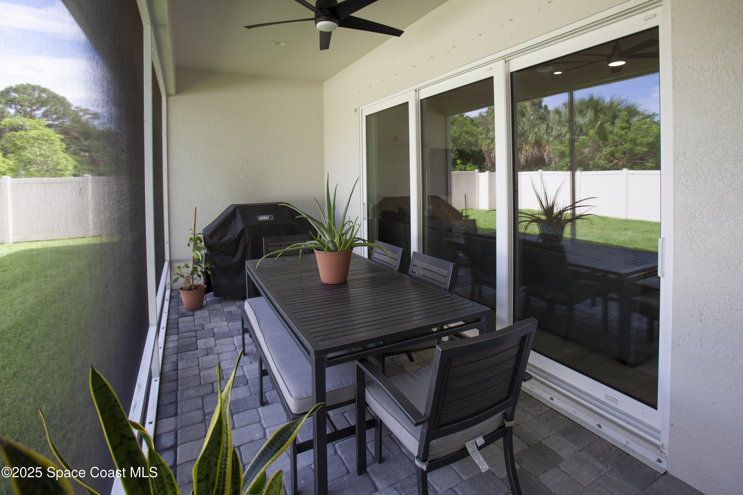 4305 Negal Circle Melbourne, FL 32901 - Photo 35 of 40 a view of a workspace with a table and chairs in patio