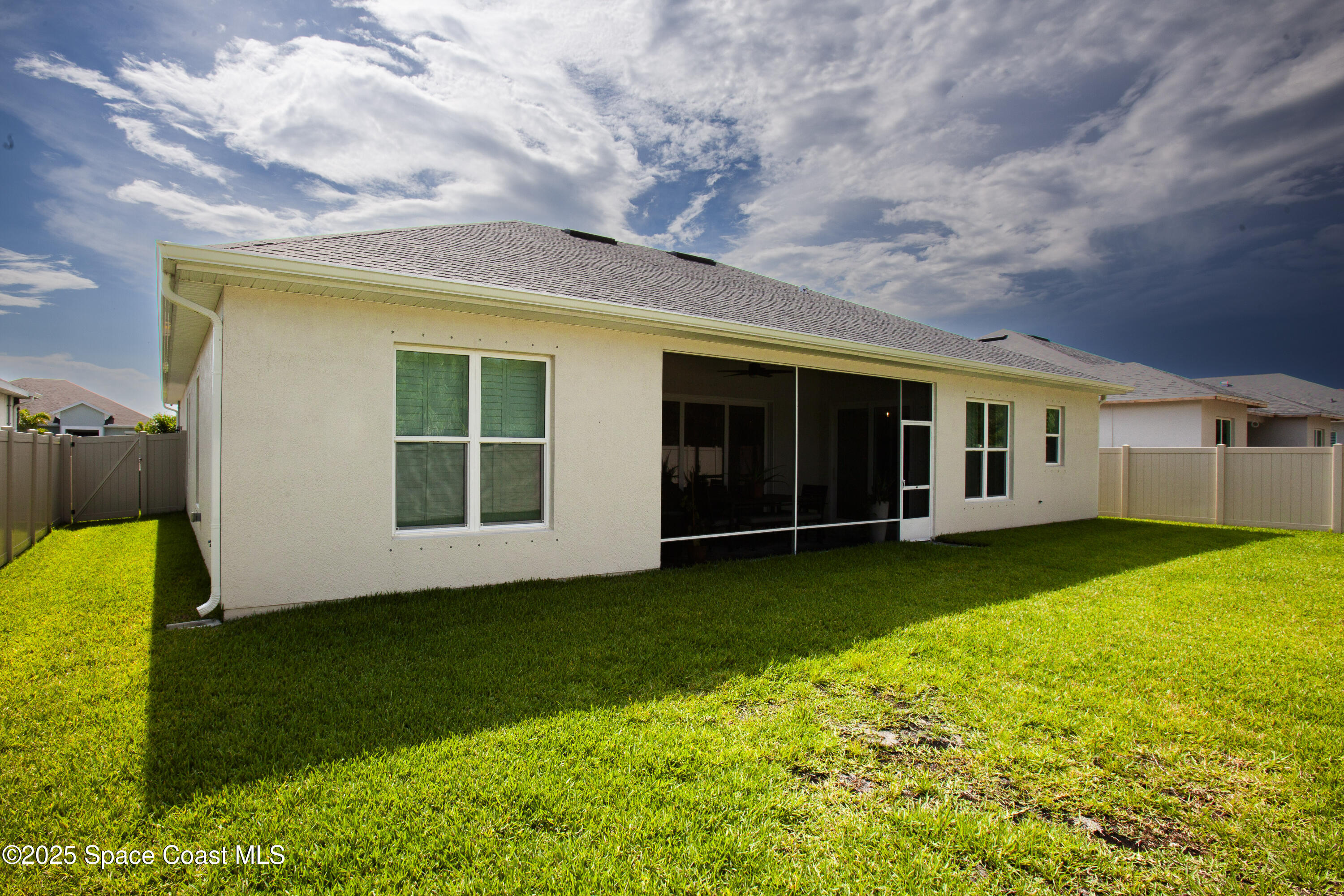4305 Negal Circle Melbourne, FL 32901 - Photo 36 of 40 a view of a backyard with plants and large tree
