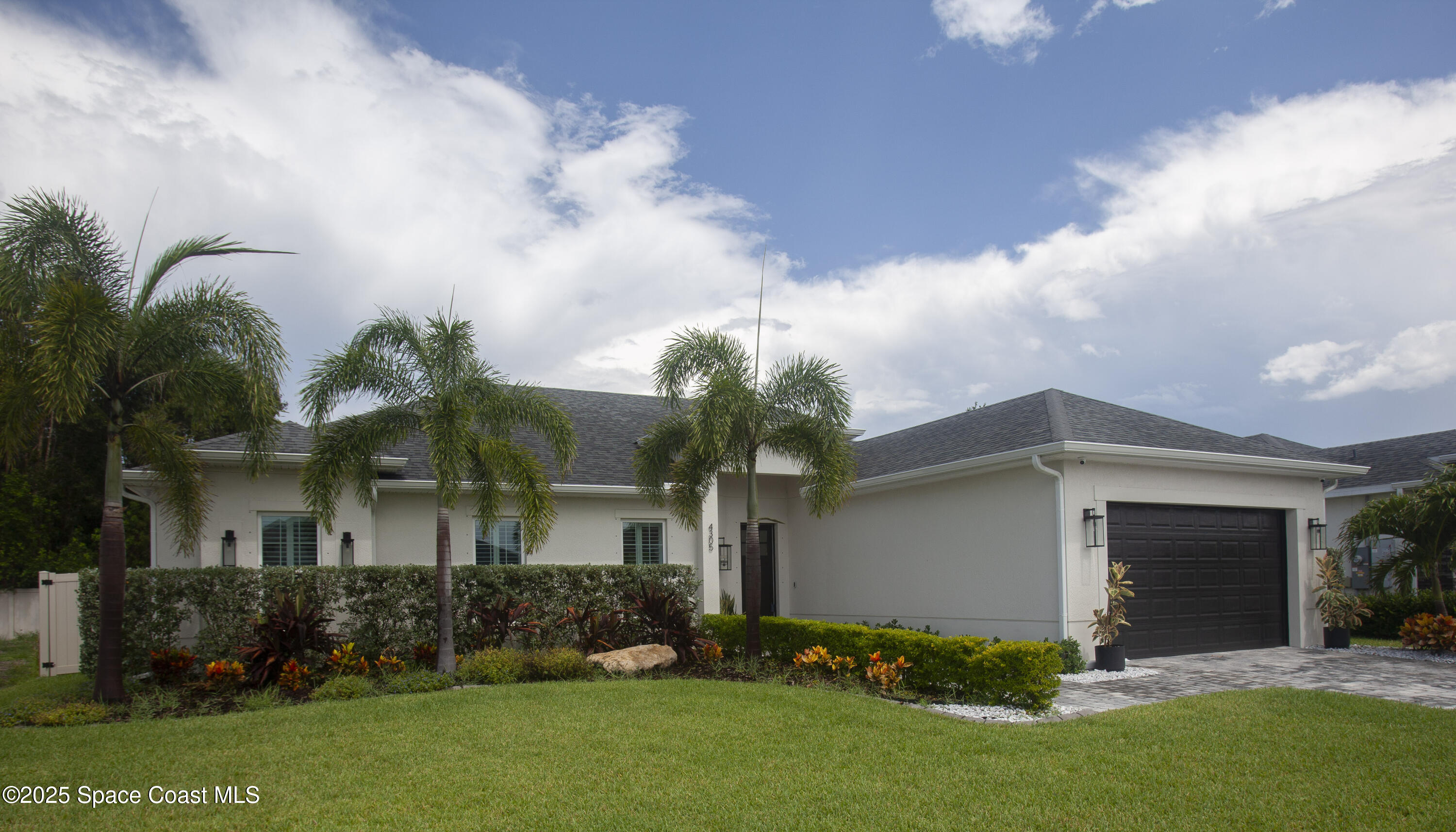 4305 Negal Circle Melbourne, FL 32901 - Photo 37 of 40 a front view of a house with a garden and yard