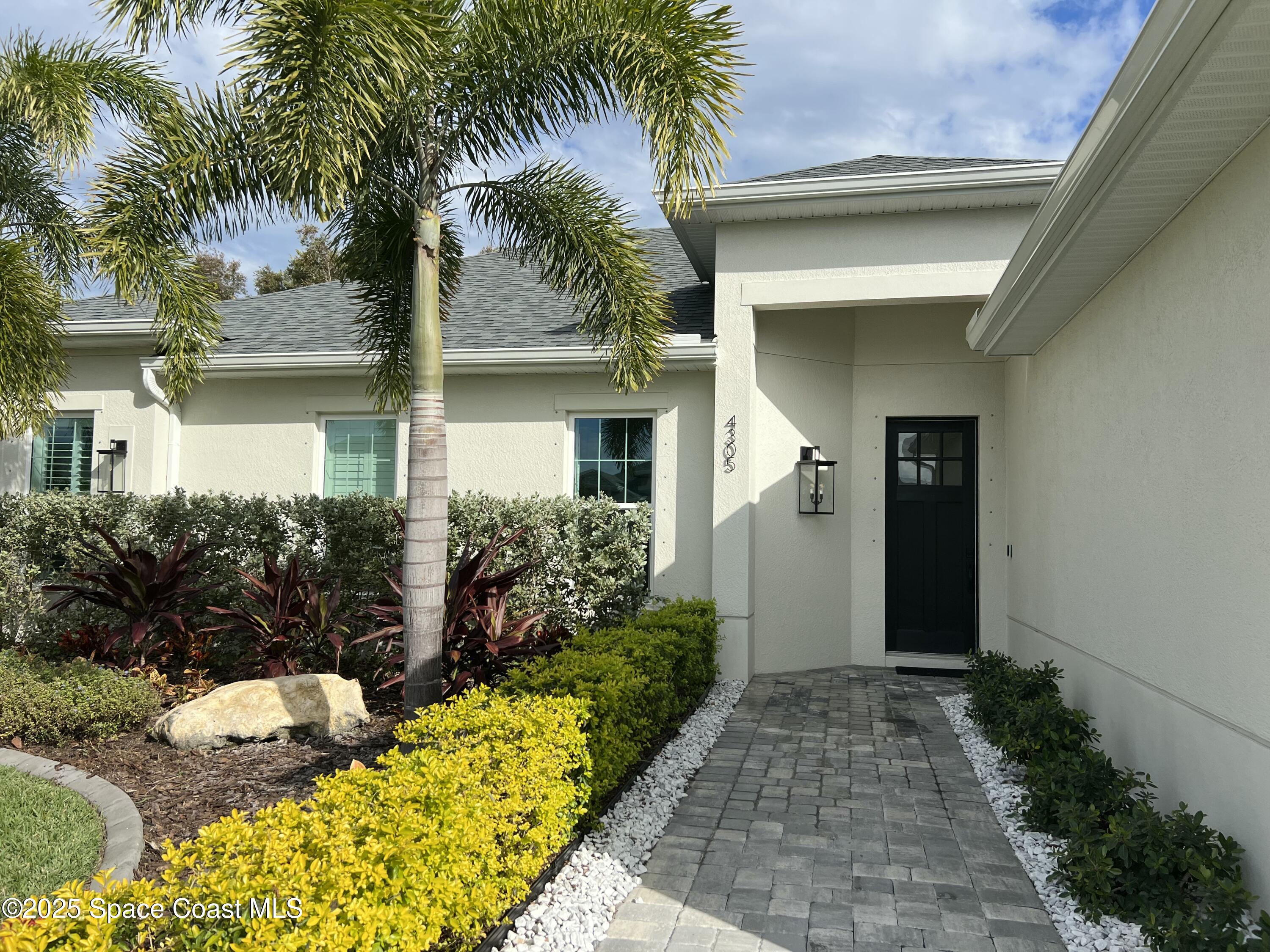 4305 Negal Circle Melbourne, FL 32901 - Photo 5 of 40 a front view of house and yard with green space