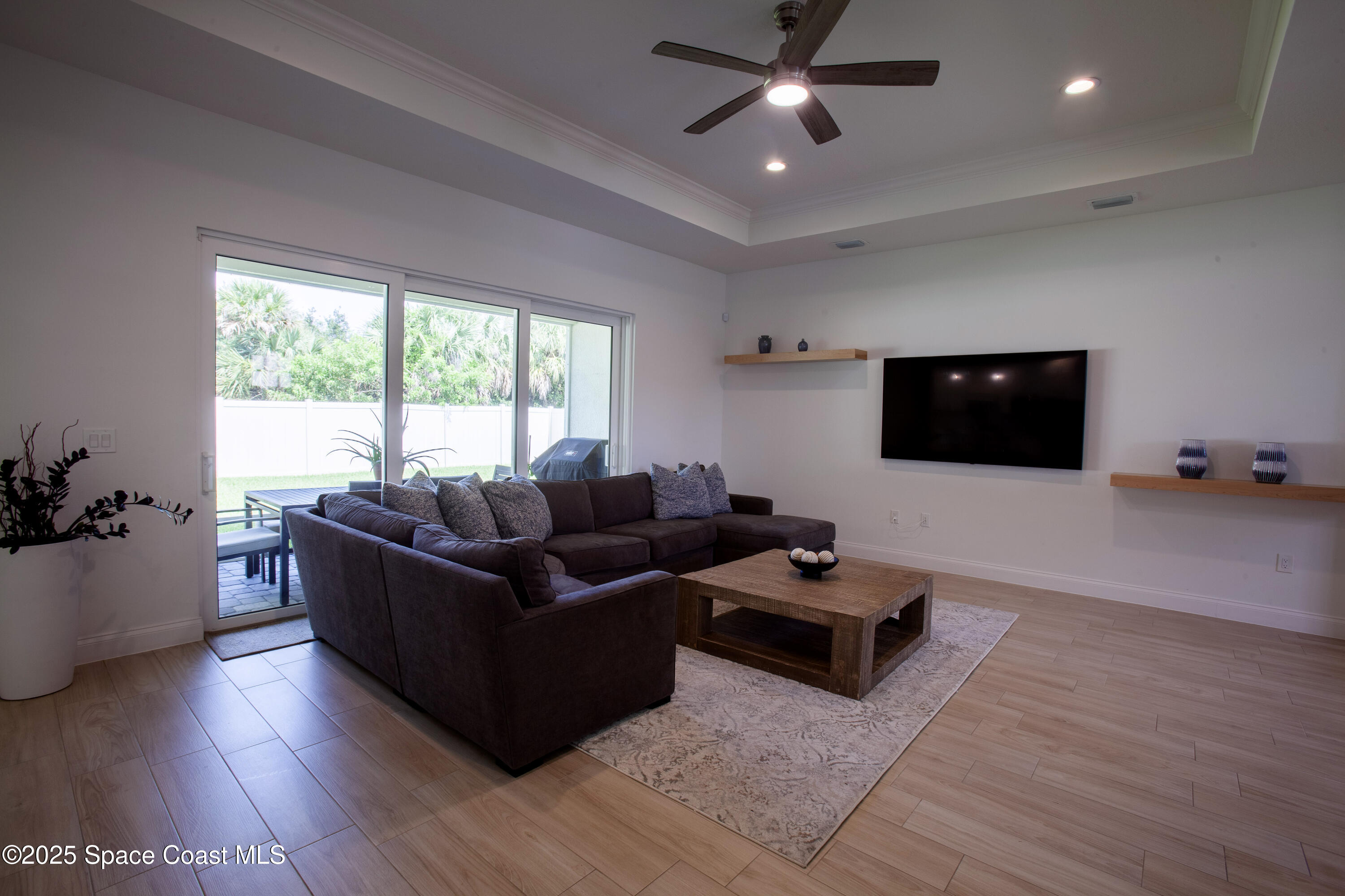 4305 Negal Circle Melbourne, FL 32901 - Photo 7 of 40 a living room with furniture and a flat screen tv