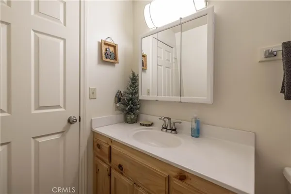 a bathroom with a sink a toilet and shower curtain
