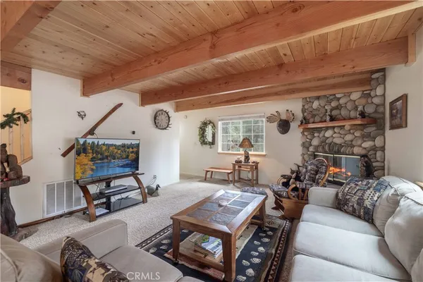 a living room with furniture a flat screen tv and a window