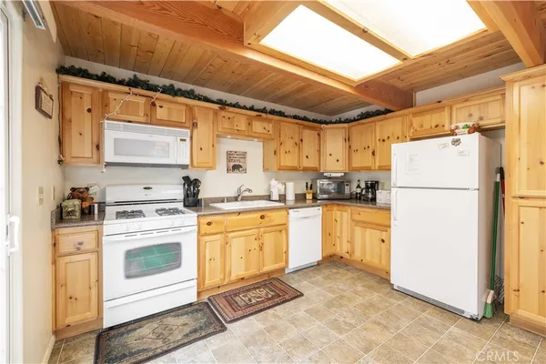 a kitchen with granite countertop a stove sink and cabinets