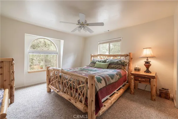 a bed sitting in a bedroom next to a window