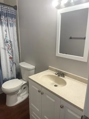 a white toilet sitting next to a bathroom sink