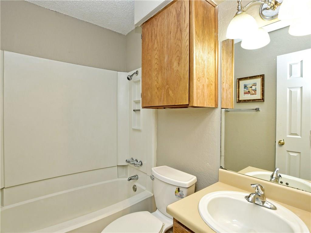 5401 Spring Meadow Road, Unit B Austin, TX 78744 - Photo 16 of 21 Well-maintained bathroom featuring a combination tub and shower alongside a functional vanity.