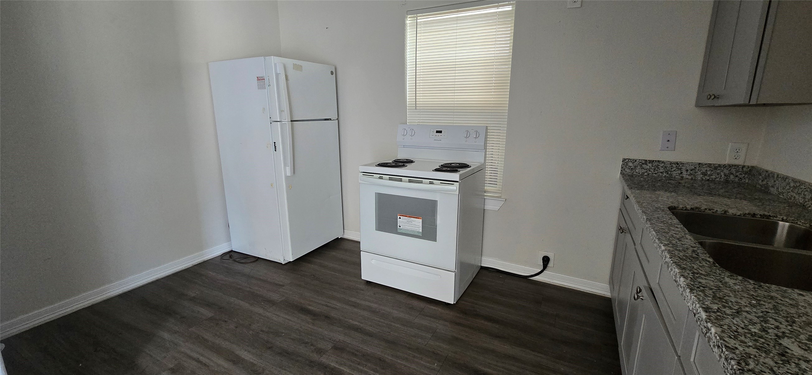 3614 Tuam Street, Unit 1 Houston, TX 77004 - Photo 5 of 6 a kitchen with wooden floors and white appliances
