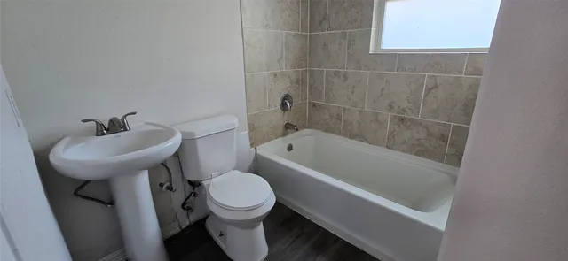 a bathroom with a sink a toilet and bathtub