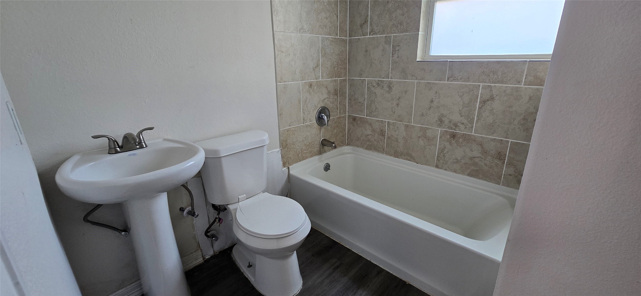 3614 Tuam Street, Unit 1 Houston, TX 77004 - Photo 6 of 6 a bathroom with a sink a toilet and bathtub