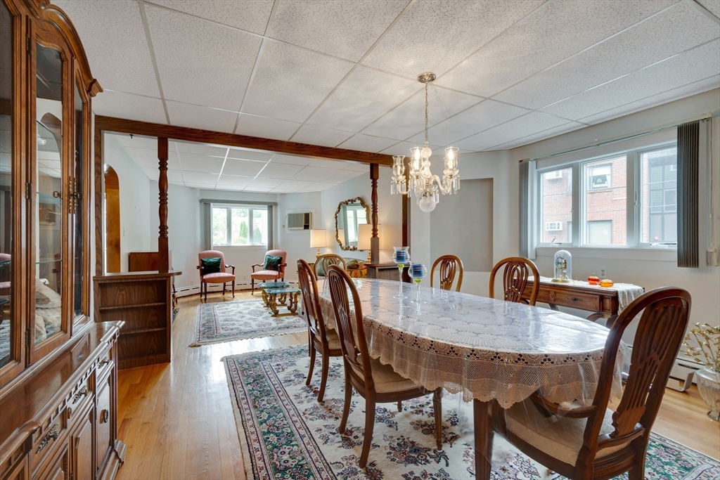 45 Jackson Road Somerville, MA 02145 - Photo 5 of 27 a dining room with furniture a chandelier and window