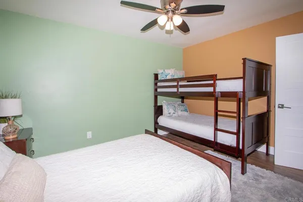a bedroom with a bed and a lamp on table