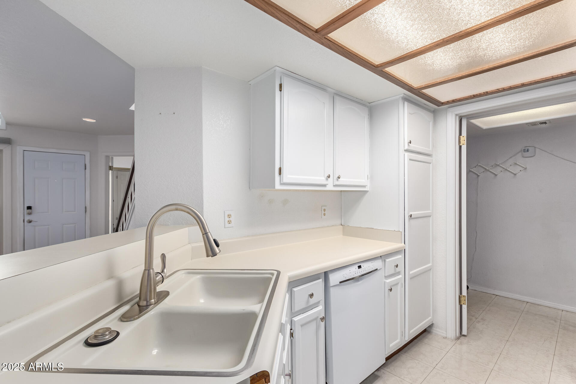 15439 North 1st Street Phoenix, AZ 85022 - Photo 11 of 26 a kitchen with white cabinets a sink and dishwasher