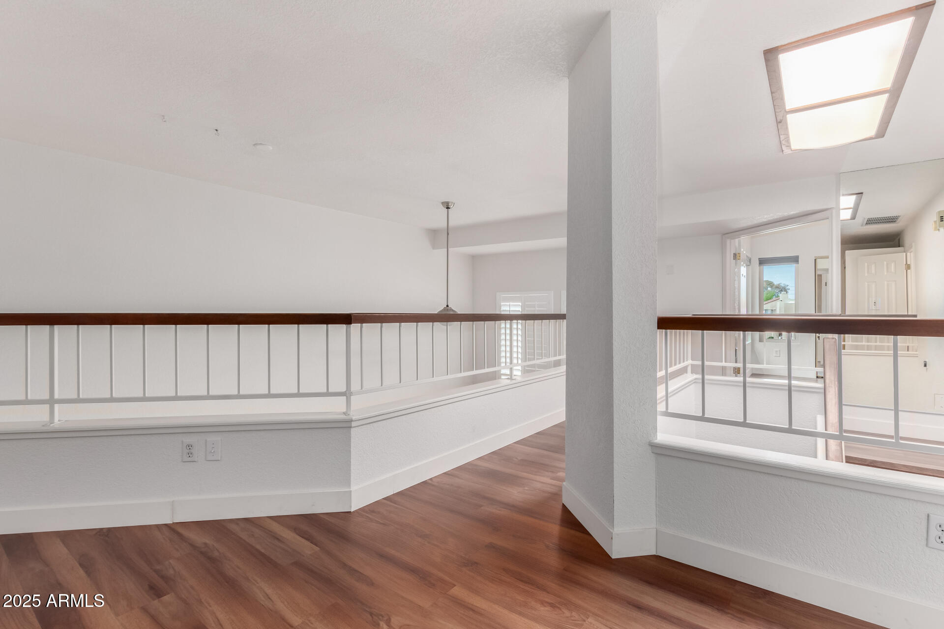 15439 North 1st Street Phoenix, AZ 85022 - Photo 17 of 26 a view of a balcony with wooden floor and windows
