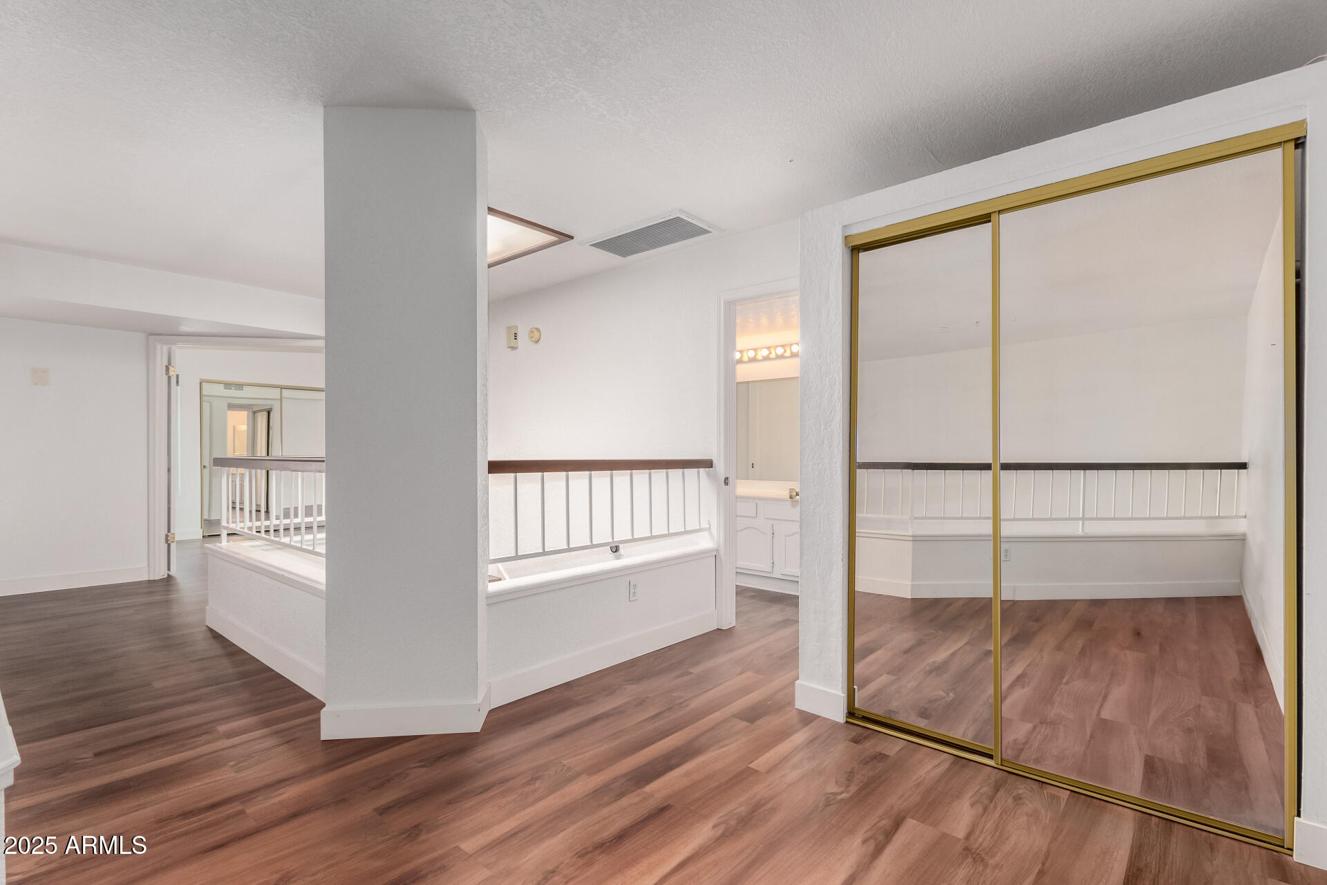 15439 North 1st Street Phoenix, AZ 85022 - Photo 18 of 26 an empty room with wooden floor and windows
