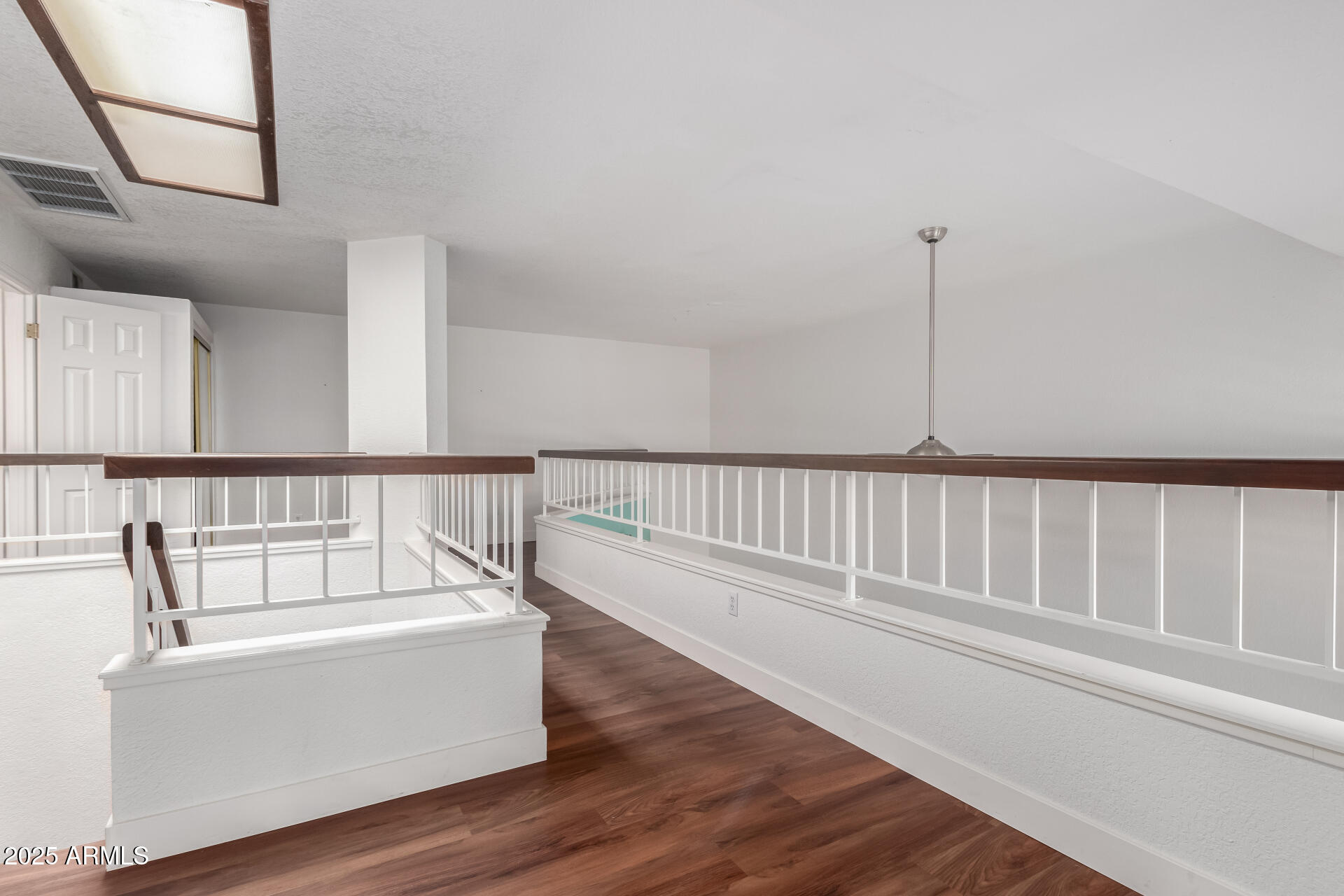 15439 North 1st Street Phoenix, AZ 85022 - Photo 19 of 26 a view of staircase with white walls and wooden floor